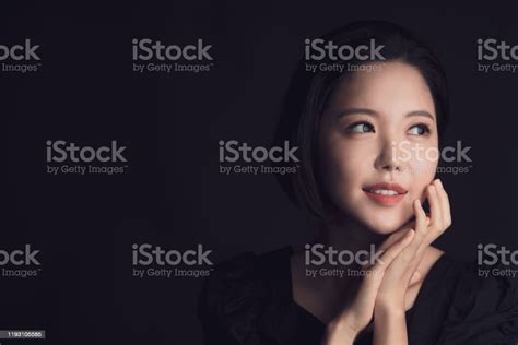 Beautiful Portrait Headshot Of Asian Korean Woman Posing Against Black