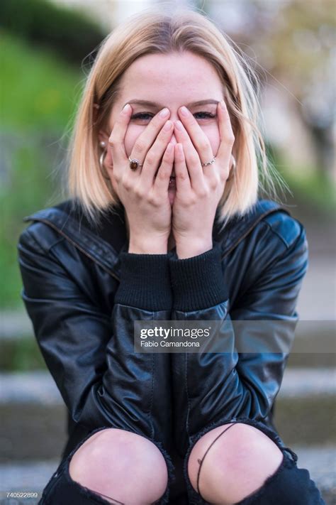 laughing caucasian woman covering face with hands in 2022 hands on