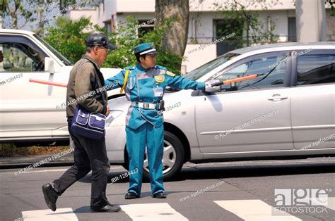 typical police officer directing traffic in a parking lot kyoto japan
