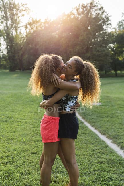 Twin Sisters Hugging Each Other In A Park — Sunshine Happy Stock
