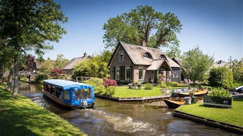 tourism people architecture house netherlands water trees garden grass village boat