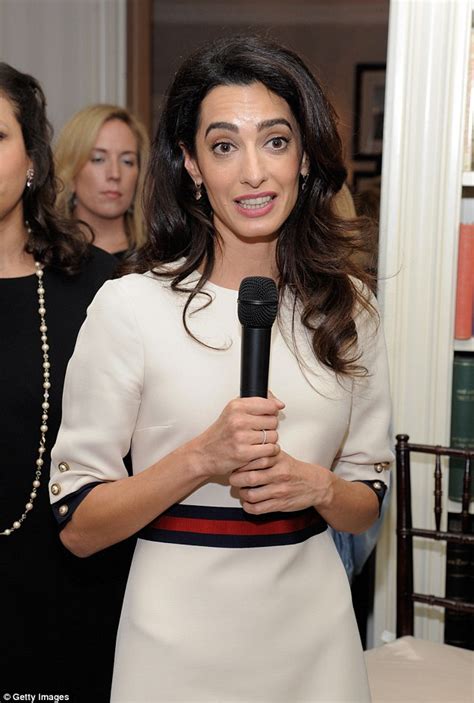 amal clooney is chic in white dress with red and blue