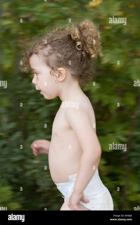 girl running  wearing   diaper stock photo alamy