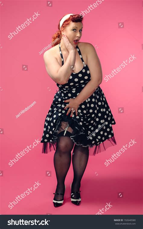 Mature Pin Up Woman Wearing 50s Style Dress Pink