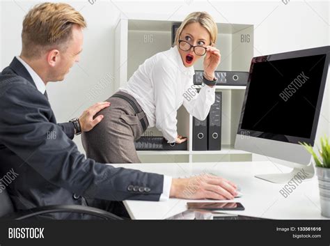 sexual harassment at the office setup man touching woman s butt stock