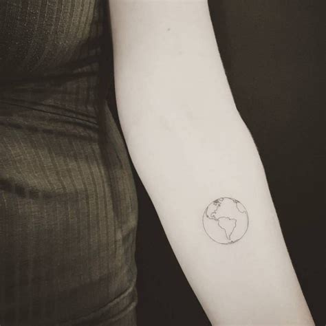 fine line planet earth tattoo on the inner forearm