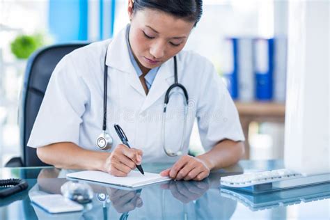 concentrated doctor writing  notebook stock photo image  chinese