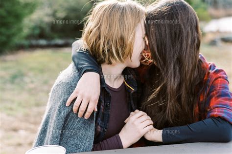 Young Lesbian Couple Cuddling Under Blanket After Hike[11100127389]の写真