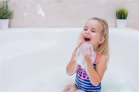 Premium Photo Little Blonde Girl Taking Bubble Bath In Beautiful