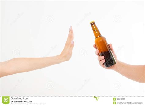 Female Hand Reject A Bottle Of Beer Isolated On White