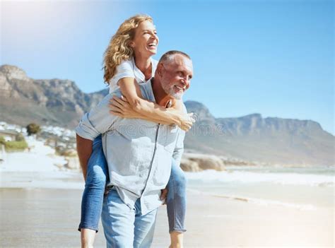 Happy Mature Couple Enjoying Vacation By The Beach Active Senior