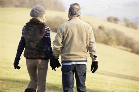 Mature Couple On Country Walk In Winter Stock Image