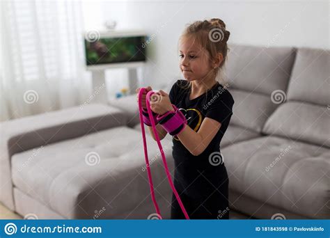 Little Cute Girl Is Practicing Gymnastics At Home Online Training