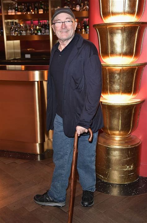 phil collins arrives at genesis rehearsals in wheelchair amid spat with