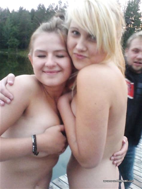lesbian teens having fun taking a dip while nude outdoors