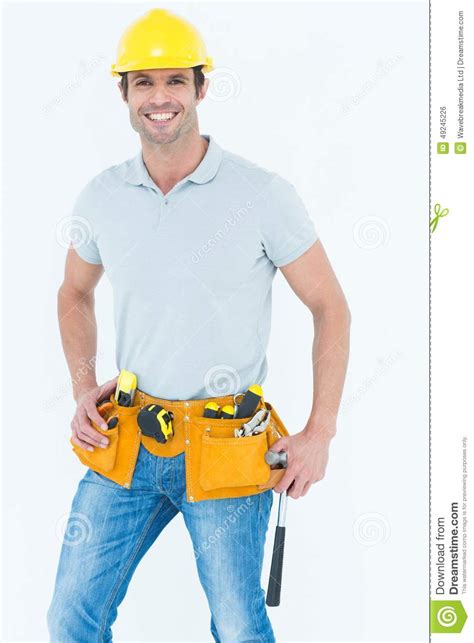 happy worker holding hammer over white background stock