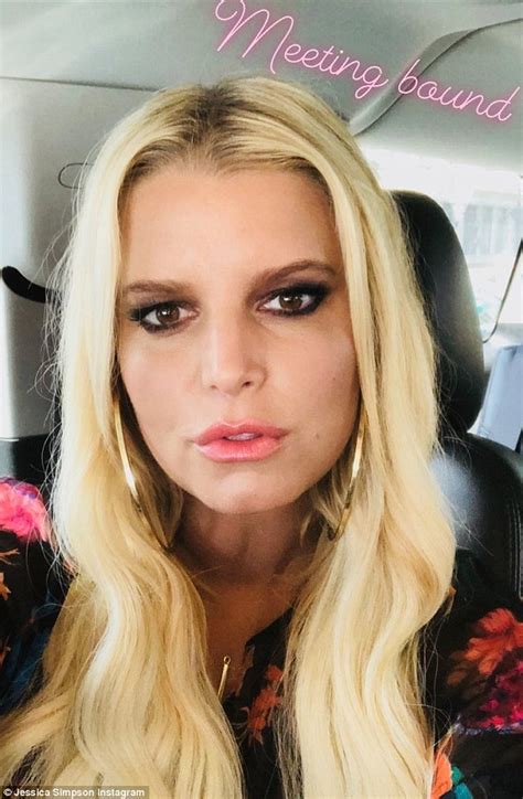 jessica simpson flashes some thigh in boots and floral