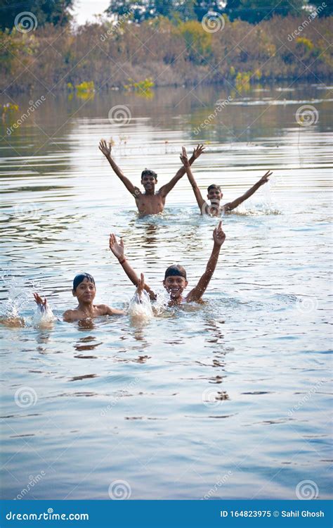 indian village boys swimming   fresh river water editorial image