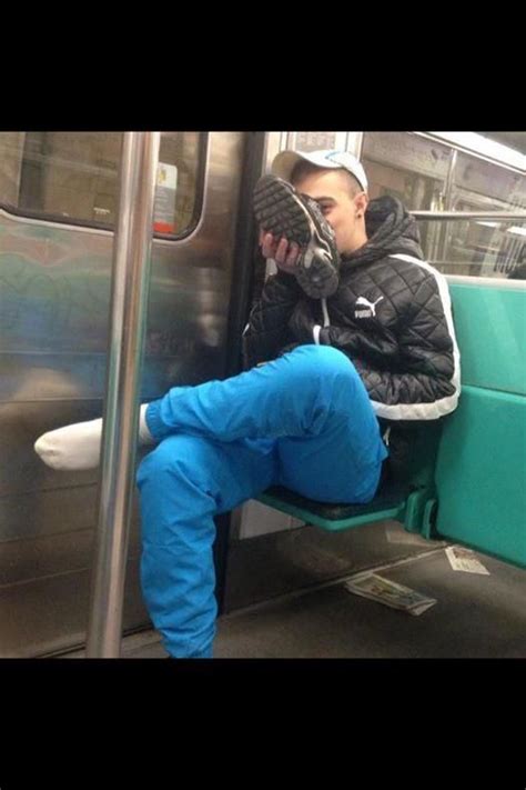 riding the train he whips his shoe off and takes a whiff heavenly sneaker sniffers