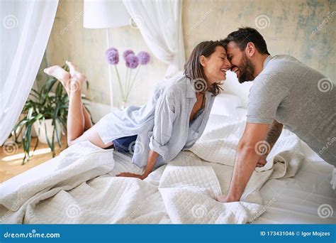 Couple Cuddling In The Morning While Making The Bed Bedroom Morning