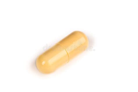 yellow pill isolated  white stock photo image  expensive