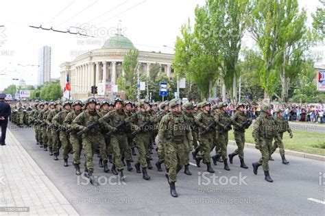 Military Men In Full Uniform With Arms March Along The