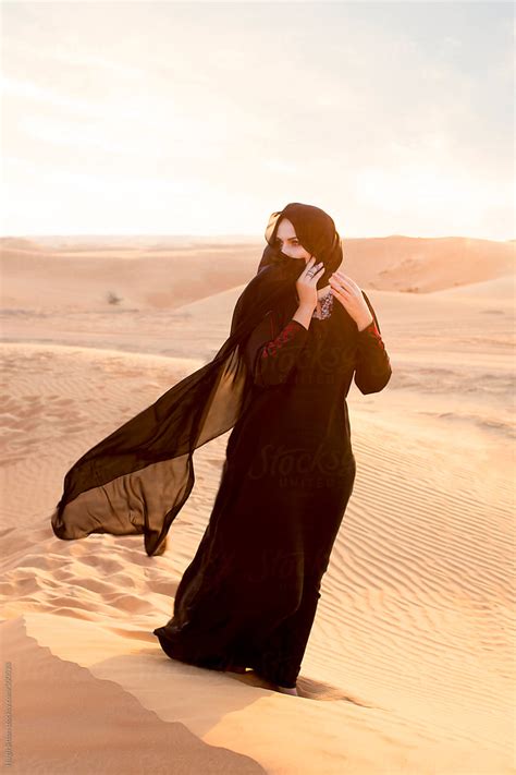 arabian woman in traditional costume dubai desert u a e by stocksy