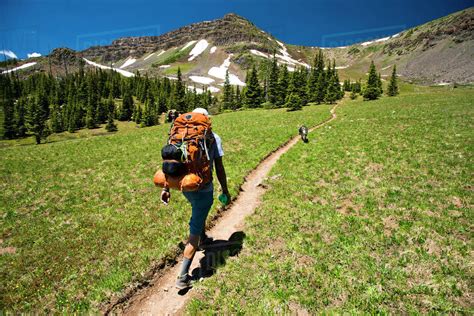 backpacker hiking   mountains stock photo dissolve