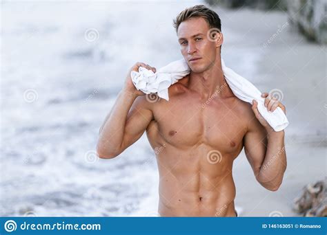 Portrait Of Tanned Fit Male Model With A Naked Torso On