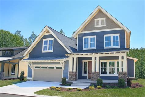 two story home blue exterior well kept landscaping