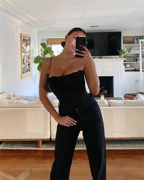 devin brugman donning a figure hugging black are you am i bodysuit with