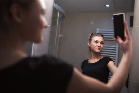 Beautiful Teenage Girl Taking A Selfie In Bathroom Stock