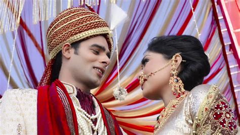 pan shot of indian bride and groom in traditional wedding dress posing