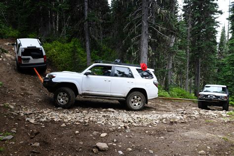 a touch of camel trophy towing a land rover through