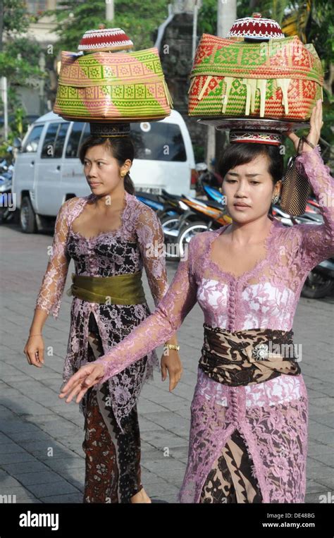 ubud bali indonesia women  traditional dress carrying  basket  offerings