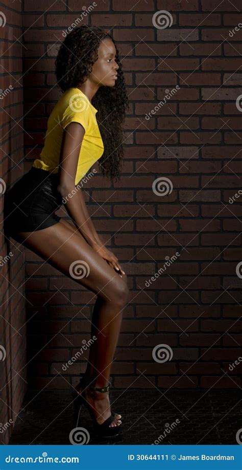 Balck Woman Leans Back Against A Brick Wall Stock Image Image Of