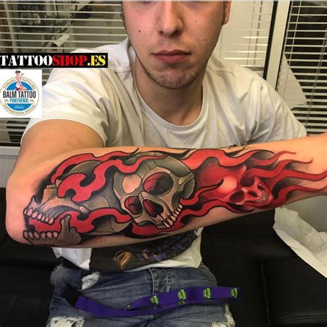 man   skull  flames tattoo   arm