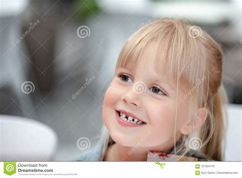 close up portrait of little cute blond caucasian girl in