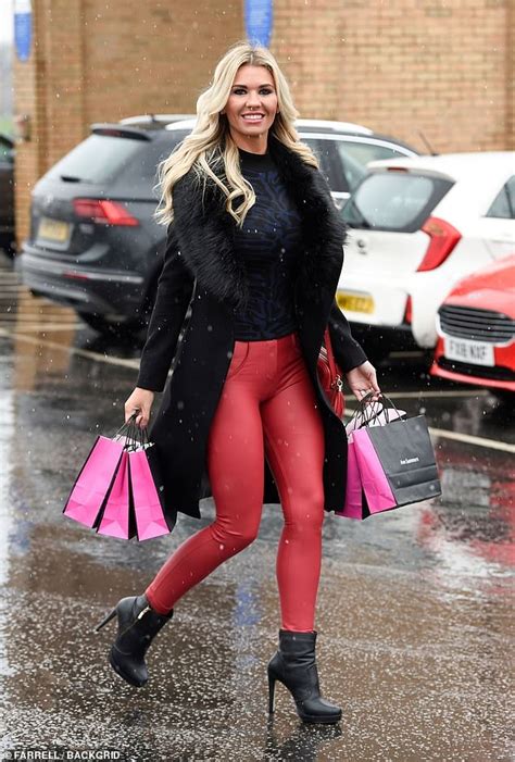 christine mcguinness stuns in skintight red pants as she carries six ann summers bags daily