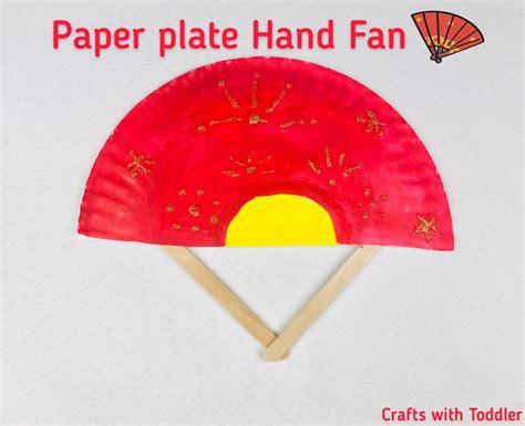 paper plate hand fan  sticks sticking    center