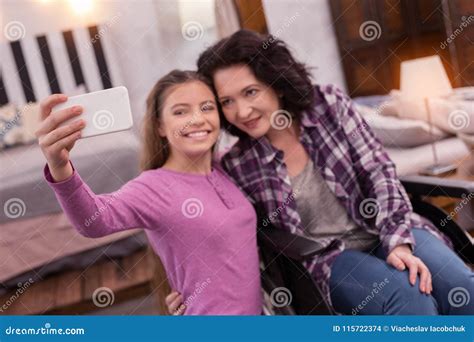 cheerful crippled woman  girl photographing stock photo image