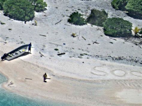 couple stranded on desert island rescued after writing sos