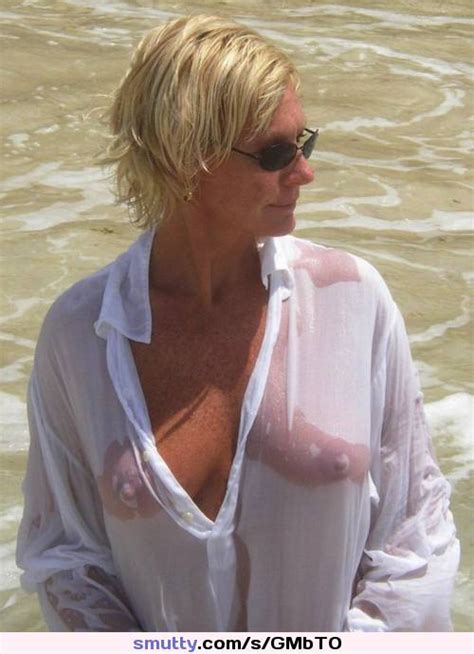 blonde milf mature sunglasses wetshirt beach vacation tanned
