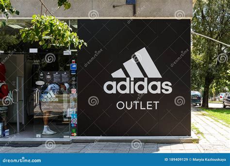 entrance  adidas outlet shop   city street   sunny summer day signboard  adidas