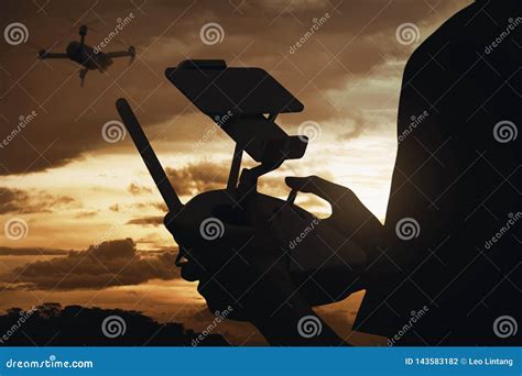 silhouette rear view  man controlling drone  flying   air stock photo image