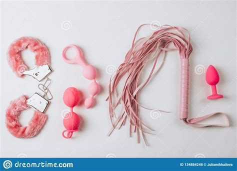 Various Pink Sex Toys Are Arranged On A White Background