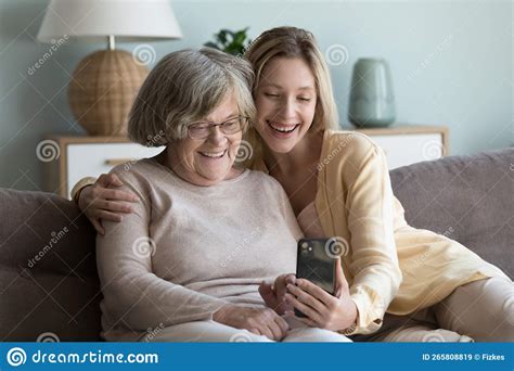 Cheerful Elderly Grandma And Adult Granddaughter Talking On Video Call