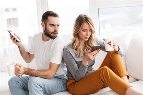 Wife Talking On Mobile Phone While Husband On Sofa Stock Image Image
