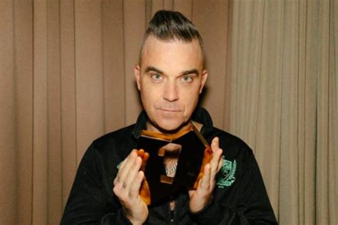 robbie williams got down on knees and prayed after developing