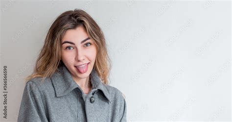 Naughty Woman Sticking Out Her Tongue At Camera As A Sign Of